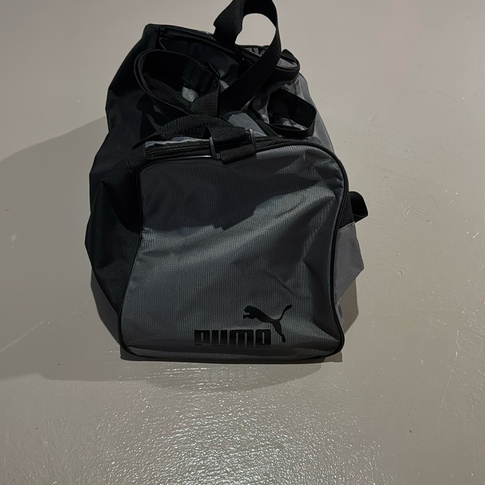 Puma black & gray duffle bag with 2 pockets and long strap. Never used